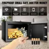 A safe box filled with gold bars and money, with a hand reaching in. Produktbild-Vorschau