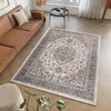 A living room scene with a brown leather sofa and a patterned rug. Produktbild-Vorschau