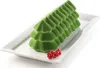 A green, Christmas tree-shaped cake on a white rectangular plate, garnished with red currants. Produktbild-Vorschau