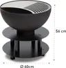 A black outdoor fire pit with a silver grill grate on a white background, with dimensions indicated. Produktbild-Vorschau