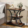 A bedside table with items on it, next to a bed. Produktbild-Vorschau