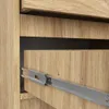 A close-up view of a wooden drawer with a metal slide mechanism. Podgląd zdjęcia produktu