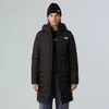 A woman wearing a black North Face parka and beanie stands against a plain background. Produktbild-Vorschau