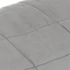 A close-up view of a quilted fabric surface. Náhľad obrázku produktu