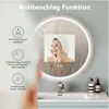 A woman with a towel on her head is shown in a bathroom setting, reflected in a round LED mirror. The mirror has condensation on it, and features icons and text highlighting its anti-fog capabilities. Anteprima dell’immagine prodotto