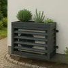 An outdoor air conditioning unit covered by a dark gray metal enclosure with a planter box on top, containing green plants. Anteprima dell’immagine prodotto