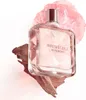 A bottle of Givenchy Irresistible Eau de Parfum is displayed with a piece of wood and a pink flower. Podgląd zdjęcia produktu