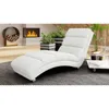 A white chaise lounge is placed in a modern living room setting with a fireplace and plants. Náhľad obrázku produktu
