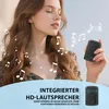 A woman is holding a small black device, with musical notes overlaid on the image. Produktbild-Vorschau