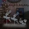 Christmas decorations including a lit tree, reindeer figures, and a sleigh. Voir les images du produit
