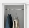 Close-up of clothes hanging on hangers inside a white wardrobe. Náhľad obrázku produktu