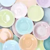 A collection of colorful ceramic plates arranged in a circular pattern. Podgląd zdjęcia produktu