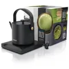 A black electric kettle and its packaging are displayed on a reflective surface. Produktbild-Vorschau