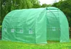 A green polyethylene greenhouse with arched supports and an open entrance, set up on a grassy lawn. Náhľad obrázku produktu