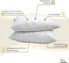 Two white pillows are stacked on a light beige background, with various features highlighted by text and icons. Produktbild-Vorschau