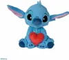 A blue Stitch plush toy holding a red heart, sitting on a white background. Podgląd zdjęcia produktu