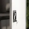 A close-up shot of a metal cabinet lock with a key inserted. Inside the cabinet, folders and files are visible on shelves. Voir les images du produit