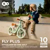 A child sits on a concrete ledge next to a balance bike in a skate park. Náhľad obrázku produktu