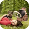 A woman and a dog lying on the grass with a pet carrier backpack. Náhľad obrázku produktu