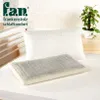 A pillow on a bed, with a plant in the background. Produktbild-Vorschau