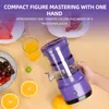 A hand holding a purple juicer with fruits and juice on a table. Podgląd zdjęcia produktu