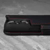 A close-up side view of a black leather iPhone case with red stitching, showing the camera cutout. Anteprima dell’immagine prodotto