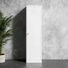 A white metal locker stands against a textured gray concrete wall, with a potted plant to its left. Náhled obrázku produktu