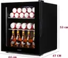 A black mini-refrigerator filled with cans of soda and bottles of beer. Voir les images du produit