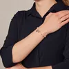 A woman's arm wearing a bracelet. Anteprima dell’immagine prodotto