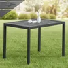 A rectangular outdoor table with water droplets on its surface, placed on a grassy lawn with blurred greenery in the background. Produktbild-Vorschau