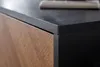 A close-up view of the corner of a lowboard, showing the textured black top and the wooden patterned side. Produktbild-Vorschau