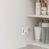 A close-up view of an open cabinet with shelves holding various cosmetic and skincare products. Podgląd zdjęcia produktu