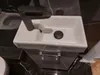 A close-up view of a white rectangular sink with a dark gray faucet, set against a dark marble-patterned background. Podgląd zdjęcia produktu
