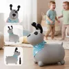 A gray inflatable dog toy with a blue bandana is shown in the foreground, with two children playing in the background. The image also includes inset photos of the dog toy. Produktbild-Vorschau
