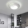 A modern living room with a ceiling light, bookshelf, and sofa. Náhled obrázku produktu