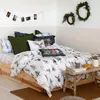 A cozy bedroom scene with a bed dressed in winter-themed bedding. Produktbild-Vorschau