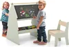 Two young children are interacting with a child-sized easel and chair set. Náhľad obrázku produktu