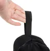 A hand holding a black strap of a backpack. Podgląd zdjęcia produktu