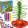 A children's dexterity game with a caterpillar-shaped tower and colorful balls, along with its packaging and accessories. Náhľad obrázku produktu