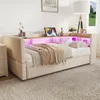 A beige upholstered daybed with a headboard featuring integrated shelves and LED lighting. Anteprima dell’immagine prodotto