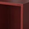 Close-up of a red metal shelf unit, showing the top edge and a side opening. Náhled obrázku produktu
