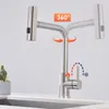 A stainless steel kitchen faucet with a flexible spout is shown in a kitchen setting. Podgląd zdjęcia produktu