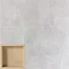A close-up of a wooden storage box integrated into a concrete-like wall. Produktbild-Vorschau