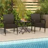 Two brown rattan chairs and a small table are set up on a patio next to a swimming pool. Produktbild-Vorschau