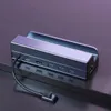 A close-up shot of a silver USB-C hub with multiple ports, resting on a dark surface with a purple gradient background. Produktbild-Vorschau