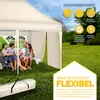 A family is enjoying a picnic under a beige pop-up gazebo in a grassy outdoor setting. Anteprima dell’immagine prodotto