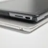 A close-up view of two electronic devices stacked on top of each other, showing their edges and ports. Produktbild-Vorschau
