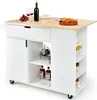 A white kitchen cart with a wooden countertop is shown against a white background. It is stocked with wine bottles, glasses, grapes, and a basket of bread. Podgląd zdjęcia produktu