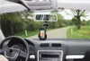 View from inside a car looking out at a road with a smartphone mounted on the dashboard displaying navigation. Náhľad obrázku produktu