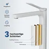A close-up marketing image of a white bathroom faucet, highlighting its layered construction and features. Anteprima dell’immagine prodotto
